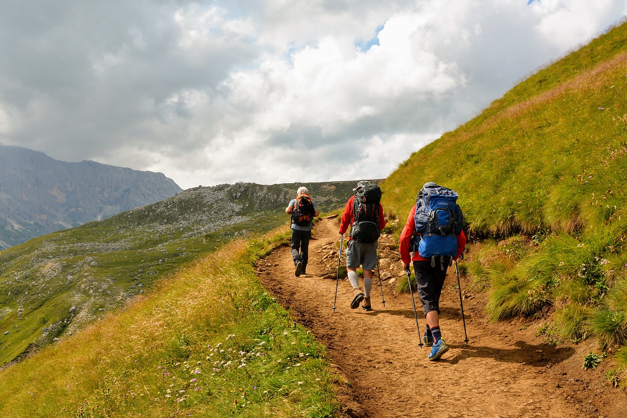 Resources for Sleep - Group of three hikers on a mountain trail from behind.
